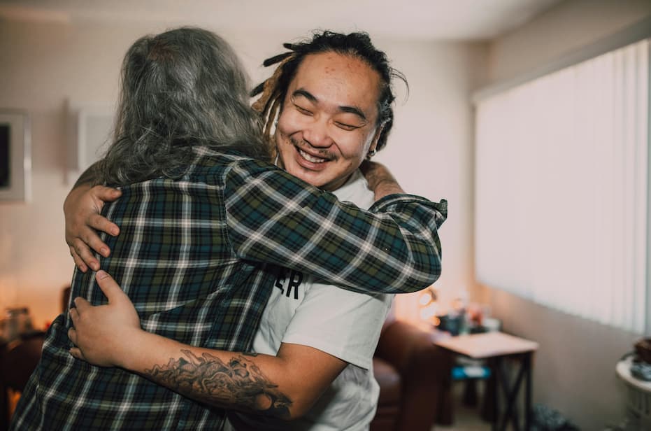 Male volunteer working and hugging person